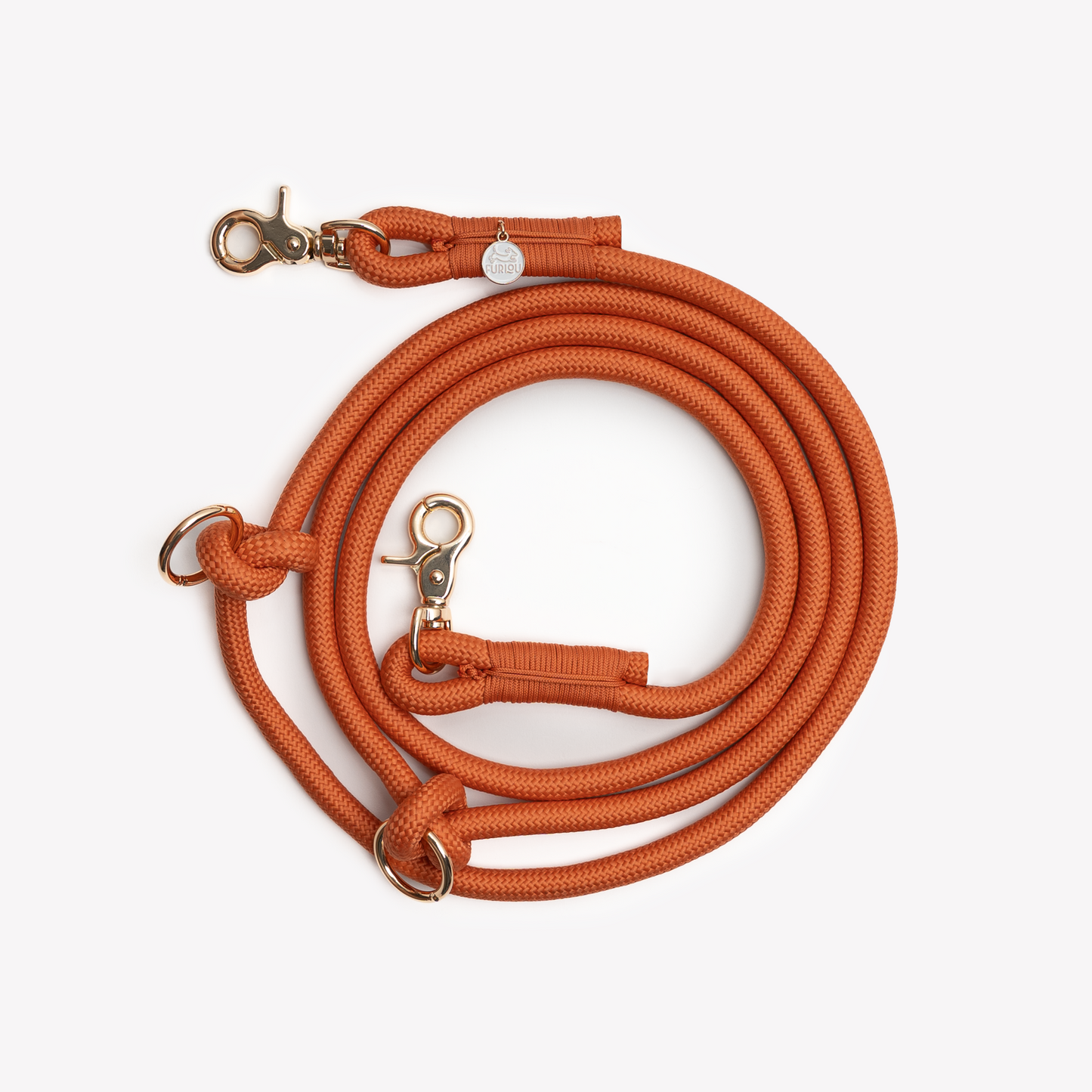Close up of braided texture and metal clip on terracotta dog leash