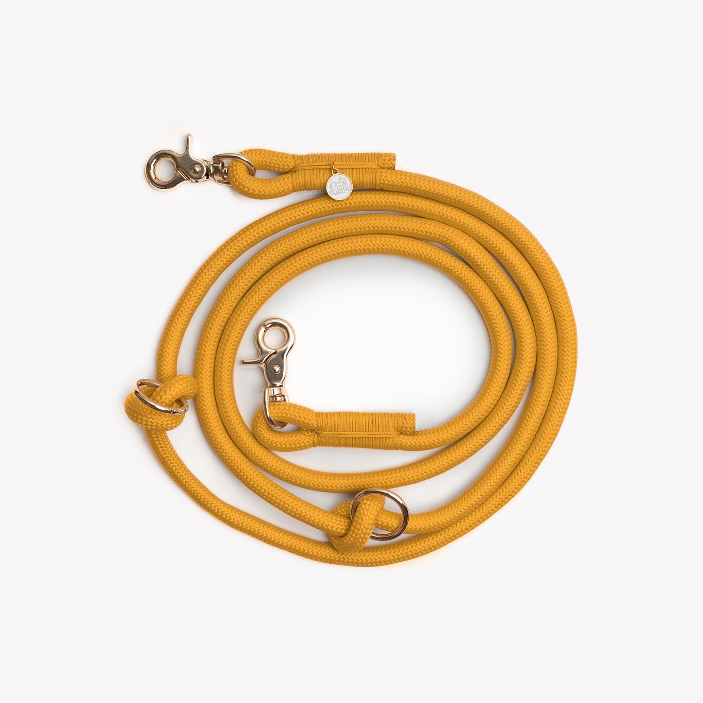 Yellow braided dog leash coiled with clip and O ring visible