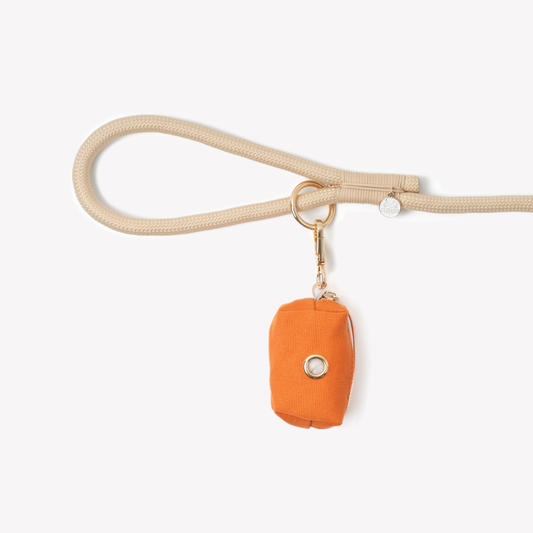 FURLOU terracotta dog poop bag holder clipped to leash during walk