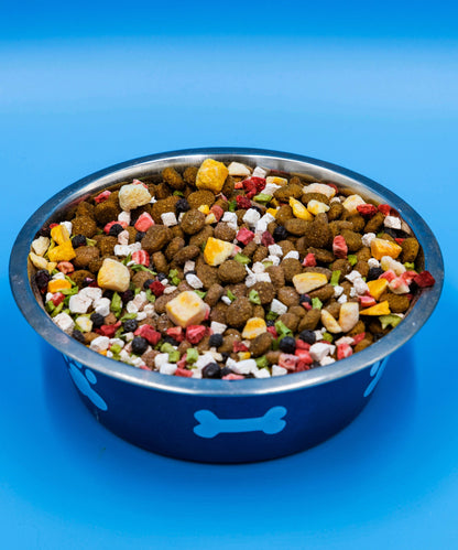 Bare Naked Chicken Mixer in a blue bowl with a bone design on a blue background